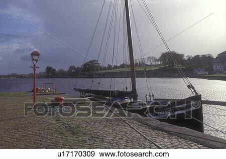 Europe, Republic of Ireland, Ireland, Sailboat docked on the cobblestone platform in Kinvarra Bay in town of Kinvarra in County Galway. View Large Photo Image Stock Photo - Europe, Republic of Ireland, Ireland, Sailboat docked on the cobblestone platform in Kinvarra Bay in town of Kinvarra in County Galway.. Fotosearch