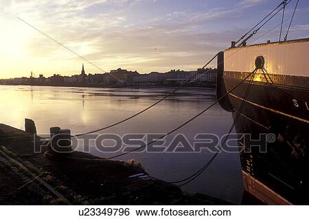 Stock Photograph -  Europe, Republic of Ireland, Ireland, Waterford, The South, Boat docked on Suir River in County Waterford at [sunrise, sunset].. Fotosearch