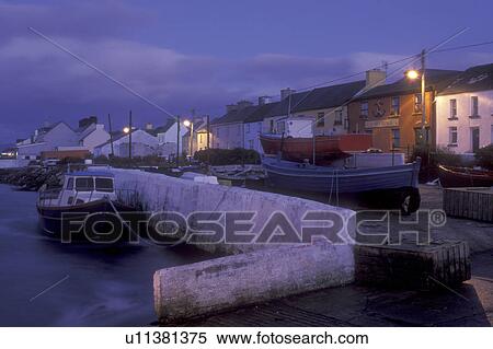Stock Photography -  Europe, Republic of Ireland, Ireland, Ring of Kerry, Portmagee, fishing boats docked at harbor in the evening in County Kerry.. Fotosearch