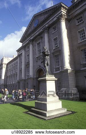 Stock Photography -  Europe, Republic of Ireland, Ireland, Dublin. A statue stands on a lush green lawn at the entrance to Trinity College, founded in 1592, in Dublin in County Dublin.. Fotosearch