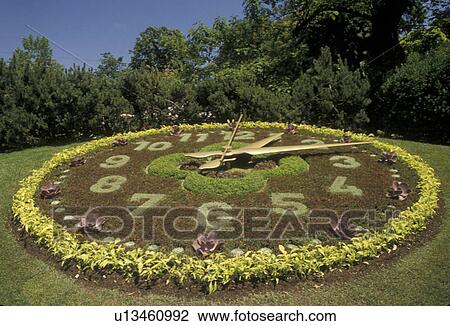 Stock Image -  floral clock, Geneva, Switzerland, Europe, Unique Floral Clock with moving parts in a park in Geneva. . Fotosearch