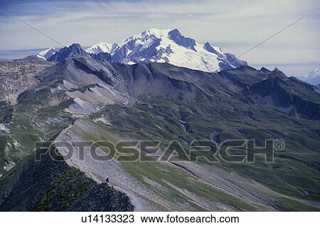 France, Alps, mountains, Mont Blanc, trail, hiking, Europe, Scenic view of the La Crete des Gites with Massif du Mont Blanc in the background. A lone hiker is hiking the GR5 and the Tour du Mont Blanc trail in the foreground. View Large Photo Image Stock Image - France, Alps, mountains, Mont Blanc, trail, hiking, Europe, Scenic view of the La Crete des Gites with Massif du Mont Blanc in the background. A lone hiker is hiking the GR5 and the Tour du Mont Blanc trail in the foreground.. Fotosearch