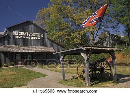 Stock Image -  Georgia, Kennesaw, museum, The conferate flag and cannon in front of the Big Shanty Museum.. Fotosearch