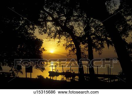 Georgia, sunset, Cumberland Island National Seashore, Sunset at Sea Camp. Boats at the dock. View Large Photo Image Stock Photograph - Georgia, sunset, Cumberland Island National Seashore, Sunset at Sea Camp. Boats at the dock.. Fotosearch