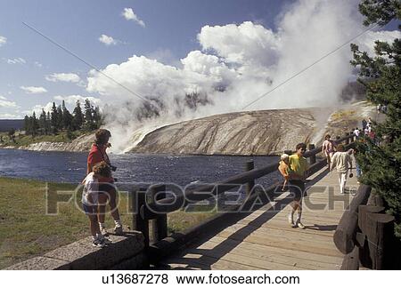 geyser, Yellowstone National Park, Biscuit Basin, Wyoming, Yellowstone, Visitors walk along the bridge over the Firehole River to watch the geysers at Biscuit Basin in Yellowstone National Park in the state of Wyoming. View Large Photo Image Stock Photo - geyser, Yellowstone National Park, Biscuit Basin, Wyoming, Yellowstone, Visitors walk along the bridge over the Firehole River to watch the geysers at Biscuit Basin in Yellowstone National Park in the state of Wyoming. . Fotosearch