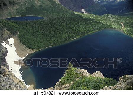 Stock Image -  Glacier National Park, glacier lake, trail, Montana, Waterton-Glacier International Peace Park, A scenic view of Pitamakan Lake and other glacier lakes in Glacier National Park.. Fotosearch