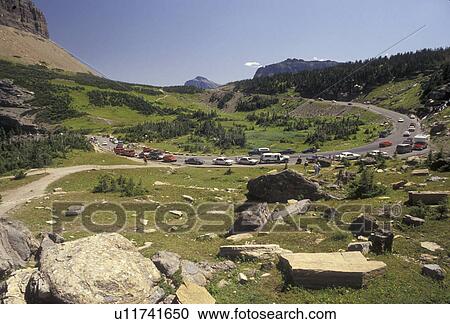 Glacier National Park, Montana, Rocky Mountains, Waterton-Glacier International Peace Park, Cars line the winding Going-to-the-Sun road through Glacier National Park in the state of Montana. View Large Photo Image Stock Image - Glacier National Park, Montana, Rocky Mountains, Waterton-Glacier International Peace Park, Cars line the winding Going-to-the-Sun road through Glacier National Park in the state of Montana.. Fotosearch