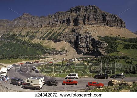 Glacier National Park, Montana, Rocky Mountains, Waterton-Glacier International Peace Park, Cars line the winding Going-to-the-Sun road through Glacier National Park in the state of Montana. View Large Photo Image Stock Image - Glacier National Park, Montana, Rocky Mountains, Waterton-Glacier International Peace Park, Cars line the winding Going-to-the-Sun road through Glacier National Park in the state of Montana.. Fotosearch
