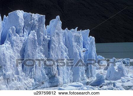 glaciers, Patagonia, Argentina, Andes, A helicopter looks tiny flying over the massive Moreno Glacier which rises 60 meters above lake level in Parque Nacional de los Glaciares (National Park) in Patagonia. View Large Photo Image Stock Image - glaciers, Patagonia, Argentina, Andes, A helicopter looks tiny flying over the massive Moreno Glacier which rises 60 meters above lake level in Parque Nacional de los Glaciares (National Park) in Patagonia. . Fotosearch