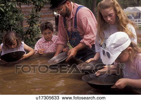 gold panning, Stone Mountain, Atlanta, Georgia's Stone Mountain Park, Georgia, Man shows children how to pan for gold during the Antebellum Jubilee at Stone Mountain Park in Atlanta in the state of Georgia. View Large Photo Image Stock Image - gold panning, Stone Mountain, Atlanta, Georgia's Stone Mountain Park, Georgia, Man shows children how to pan for gold during the Antebellum Jubilee at Stone Mountain Park in Atlanta in the state of Georgia. . Fotosearch