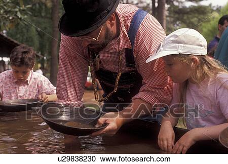 gold panning, Stone Mountain, Atlanta, Georgia's Stone Mountain Park, Georgia, Man shows children how to pan for gold during the Antebellum Jubilee at Stone Mountain Park in Atlanta in the state of Georgia. View Large Photo Image Stock Image - gold panning, Stone Mountain, Atlanta, Georgia's Stone Mountain Park, Georgia, Man shows children how to pan for gold during the Antebellum Jubilee at Stone Mountain Park in Atlanta in the state of Georgia. . Fotosearch
