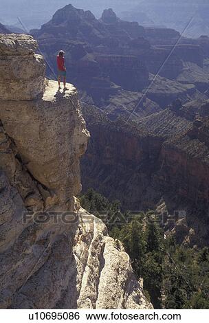 Grand Canyon, Grand Canyon National Park, Arizona, Man standing on the edge of Bright Angel Point on the North Rim of the Grand Canyon Nat'l Park in the state of Arizona. View Large Photo Image Stock Photograph - Grand Canyon, Grand Canyon National Park, Arizona, Man standing on the edge of Bright Angel Point on the North Rim of the Grand Canyon Nat'l Park in the state of Arizona.. Fotosearch