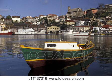 Grenada, Caribbean, St. George's, Caribbean Islands, Green fishing boat anchored in the calm waters of the Carenage Harbor with a scenic view of St. George's the capital city on the steep hillside on the island of Grenada the spice isle (a British Common View Large Photo Image Stock Photograph - Grenada, Caribbean, St. George's, Caribbean Islands, Green fishing boat anchored in the calm waters of the Carenage Harbor with a scenic view of St. George's the capital city on the steep hillside on the island of Grenada the spice isle (a British Common. Fotosearch