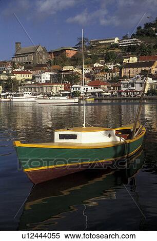 Grenada, Caribbean, St. George's, Caribbean Islands, Green fishing boat anchored in the calm waters of the harbor with a scenic view of St. George's the capital city on the island of Grenada the spice isle (a British Commonwealth member). View Large Photo Image Stock Photography - Grenada, Caribbean, St. George's, Caribbean Islands, Green fishing boat anchored in the calm waters of the harbor with a scenic view of St. George's the capital city on the island of Grenada the spice isle (a British Commonwealth member).. Fotosearch