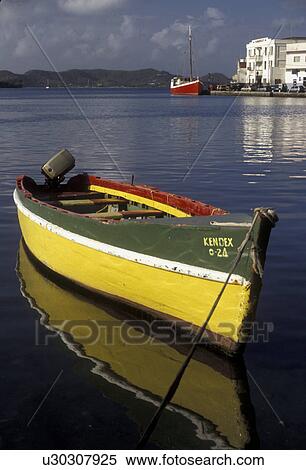 Grenada, Caribbean, St. George's, Caribbean Islands, Green and yellow fishing boat reflects in the calm waters on the harbor of St. George's the capital city of the island of Grenada the spice isle (a British Commonwealth member). View Large Photo Image Stock Photography - Grenada, Caribbean, St. George's, Caribbean Islands, Green and yellow fishing boat reflects in the calm waters on the harbor of St. George's the capital city of the island of Grenada the spice isle (a British Commonwealth member).. Fotosearch