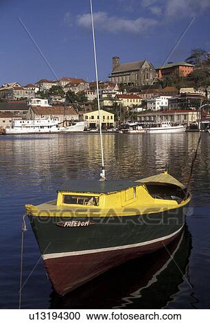 Grenada, St. George's, Caribbean, Caribbean Islands, Green fishing boat anchored in the calm waters of the harbor with a scenic view of St. George's the capital city on the island of Grenada the spice isle (a British Commonwealth member). View Large Photo Image Stock Image - Grenada, St. George's, Caribbean, Caribbean Islands, Green fishing boat anchored in the calm waters of the harbor with a scenic view of St. George's the capital city on the island of Grenada the spice isle (a British Commonwealth member).. Fotosearch