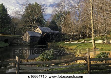 Stock Image -  grist mill, Virginia, Blue Ridge Parkway, View of Mabry Mill an old grist mill on a pond surrounded by a split rail fence along the Blue Ridge Parkway in the Southern Appalachians.. Fotosearch