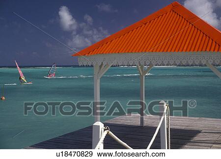 Stock Photo -  Guadeloupe, Caribbean, resort, Caribbean Islands, Scenic view of windsurfing on the blue-green water of the Caribbean Sea from the red roof pier at Hotel Meridien in St. Francois on the island of Grande-Terre in Guadeloupe (a french department) The Emera. Fotosearch
