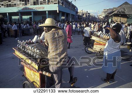 Stock Image -  Haiti, Caribbean, Haitian people with street bar carts in the city of Port-Au-Prince capital of Haiti . Fotosearch