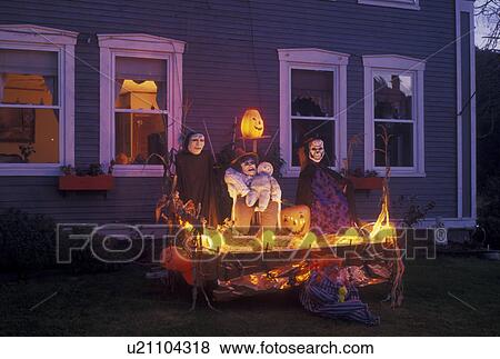 Stock Photo -  Halloween, decoration, season, Vermont, A spooky Halloween decoration is displayed in front of a house in the evening in the town of Marshfield in Washington County in the state of Vermont. . Fotosearch