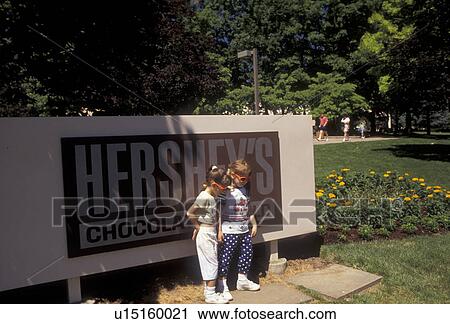 Hershey, Pennsylvania, Hershey's Chocolate World, Young girls standing in front of Hershey Chocolate sign posing for a picture at the entrance to Hershey's Chocolate World in Hershey in the state of Pennsylvania. View Large Photo Image Stock Image - Hershey, Pennsylvania, Hershey's Chocolate World, Young girls standing in front of Hershey Chocolate sign posing for a picture at the entrance to Hershey's Chocolate World in Hershey in the state of Pennsylvania. . Fotosearch