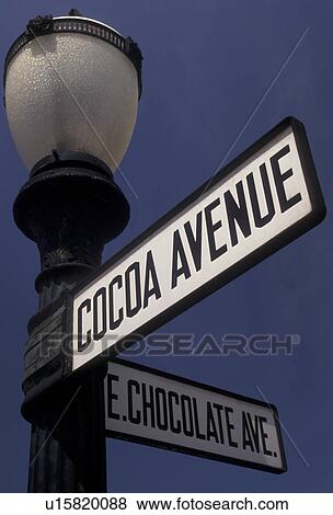 Hershey, street signs, chocolate, Pennsylvania, Cocoa Avenue and East Chocolate Avenue road sign on a black lamp post against a blue sky in downtown Hershey in the state of Pennsylvania. View Large Photo Image Stock Photo - Hershey, street signs, chocolate, Pennsylvania, Cocoa Avenue and East Chocolate Avenue road sign on a black lamp post against a blue sky in downtown Hershey in the state of Pennsylvania.. Fotosearch