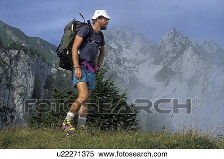 Stock Photography -  hiker, backpacking, Alps, France, Europe, Haut-Savoie, Man hiking with a backpack in the French Alps near Neuteu along the GR5 trail. . Fotosearch