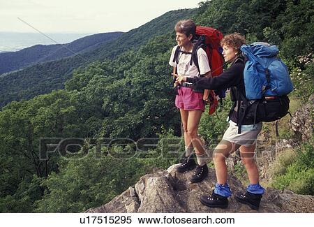 hiking, hikers, backpacking, Shenandoah National Park, Blue Ridge, Appalachian Mountains, Appalachian Trail, National Scenic Trail, Virginia, Two women hiking the long distance Appalachian Trail with backpacks look out over the Shenandoah National Park i View Large Photo Image Stock Photography - hiking, hikers, backpacking, Shenandoah National Park, Blue Ridge, Appalachian Mountains, Appalachian Trail, National Scenic Trail, Virginia, Two women hiking the long distance Appalachian Trail with backpacks look out over the Shenandoah National Park i. Fotosearch