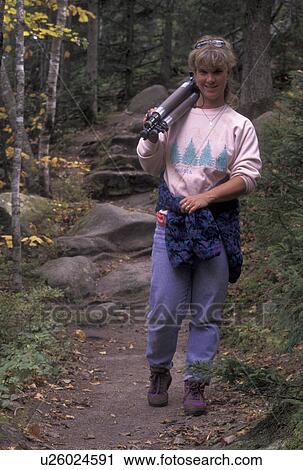hiking, trail, Vermont, A woman hiking on a trail in the fall carries a tripod in Groton State Forest in Caledonia County in the state of Vermont. View Large Photo Image Stock Image - hiking, trail, Vermont, A woman hiking on a trail in the fall carries a tripod in Groton State Forest in Caledonia County in the state of Vermont. . Fotosearch