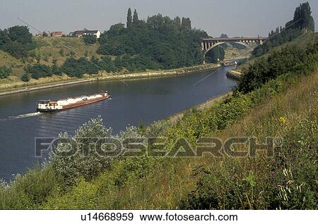 Stock Photo -  Holland, Netherlands, Europe, A barge cruises down the Albert Canal near Masstricht.. Fotosearch