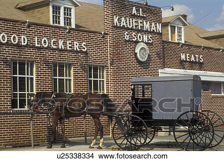 Picture -  horse and buggy, amish, store, Amish country, Lancaster County, Pennsylvania, Pennsylvania Dutch Country, An Amish horse and buggy wait outside Kauffman's Frozen Food Lockers grocery store in Intercourse in the state of Pennsylvania. . Fotosearch