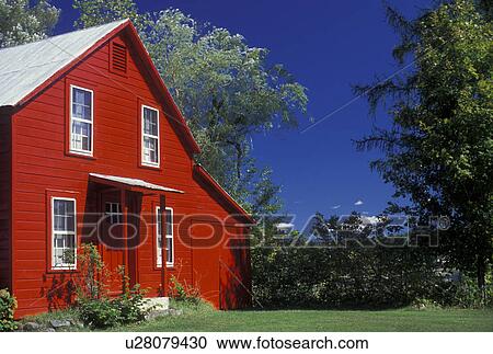 Stock Image -  house, Adirondack Park, New York, Adirondacks, A bright red farmhouse with a gray roof in Wells in the adirondack Park in the state of New York.. Fotosearch