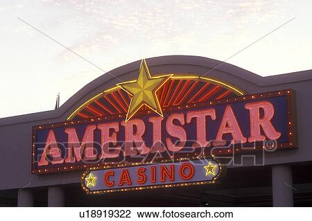 Stock Image -  Iowa, Council Bluffs, Ameristar Casino entrance sign lighted in the evening, . Fotosearch