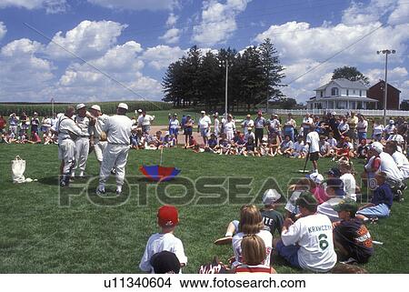 Iowa, Dyersville, Field of Dreams Movie Site in Dyersville. Crowd of people watch The Ghost Team play an exhibition baseball game with children View Large Photo Image Picture - Iowa, Dyersville, Field of Dreams Movie Site in Dyersville. Crowd of people watch The Ghost Team play an exhibition baseball game with children . Fotosearch