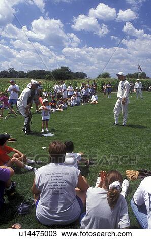 Iowa, Dyersville, Field of Dreams Movie Site in Dyersville. Crowd of people watch The Ghost Team play an exhibition baseball game with children View Large Photo Image Stock Image - Iowa, Dyersville, Field of Dreams Movie Site in Dyersville. Crowd of people watch The Ghost Team play an exhibition baseball game with children . Fotosearch