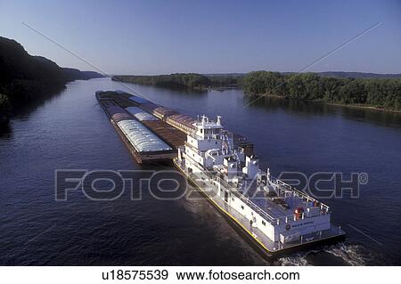 Iowa, Marquette, A barge carrying cargo chugs down the Mississippi River in Marquette View Large Photo Image Stock Photo - Iowa, Marquette, A barge carrying cargo chugs down the Mississippi River in Marquette . Fotosearch