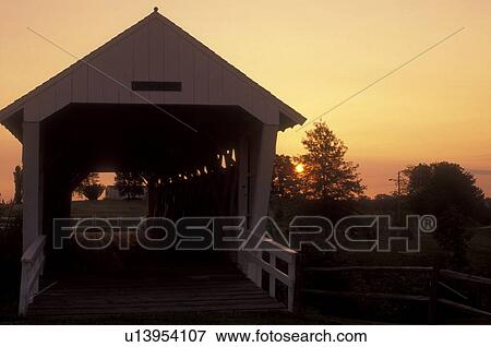 Stock Photo -  Iowa, St. Charles, covered bridge, circa 1870 Ives Covered Bridge at [sunrise, sunset] in St. Charles. Bridges of Madison County.. Fotosearch