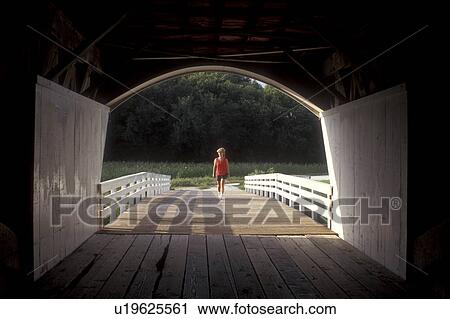 Iowa, Winterset, covered bridge, Woman walking towards circa 1883 Roseman Covered Bridge in Winterset. Bridges of Madison County. View Large Photo Image Stock Image - Iowa, Winterset, covered bridge, Woman walking towards circa 1883 Roseman Covered Bridge in Winterset. Bridges of Madison County.. Fotosearch