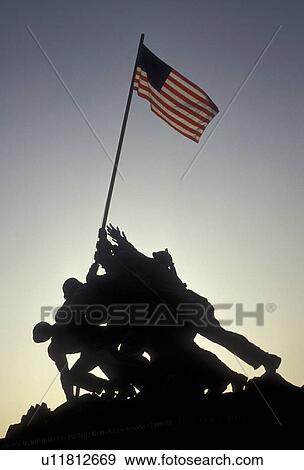 Stock Photo -  Iwo Jima, Marine Corps War Memorial, silhouette, Arlington National Cemetery, Arlington, Virginia, A silhouette of the raising of the U. S. flag at Iwo Jima, Marine Corps War Memorial at Arlington National Cemetery in Arlington in the state of Virginia.. Fotosearch