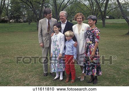Stock Image -  Jimmy Carter, Plains, Georgia, Former president Jimmy Carter and wife Rosalyn pose for a picture with a family outside the Maranatha Baptist Church on a Sunday morning in Plains in the state of Georgia.. Fotosearch