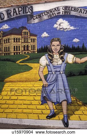 Judy Garland, mural, Minnesota, Wizard of Oz, Judy Garland and The Yellow Brick Road mural is painted on the side of a brick building in downtown Grand Rapids birthplace of Judy Garland in the state of Minnesota. View Large Photo Image Picture - Judy Garland, mural, Minnesota, Wizard of Oz, Judy Garland and The Yellow Brick Road mural is painted on the side of a brick building in downtown Grand Rapids birthplace of Judy Garland in the state of Minnesota.. Fotosearch