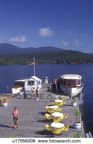 Stock Photo -  Lake Placid, Adirondack Park, Adirondacks, New York, Scenic view of Lake Placid. Cruise boat is docked waiting for passengers in the state of New York.. Fotosearch