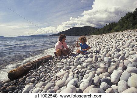 Lake Superior, rocky beach, Ontario, Canada, Mother and daughter looking at round rocks made by erosion on Pebble Beach in Marathon on Lake Superior in the Province of Ontario, Canada. View Large Photo Image Stock Photo - Lake Superior, rocky beach, Ontario, Canada, Mother and daughter looking at round rocks made by erosion on Pebble Beach in Marathon on Lake Superior in the Province of Ontario, Canada.. Fotosearch
