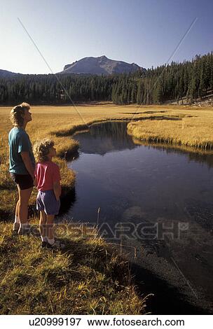 Stock Photo -  Lassen Volcanic National Park, Lassen, California, Cascade Mountains, Cascade Range, Mother and daughter (7 years old) stand next to Kings Creek in Lassen Volcanic Nat'l Park in the state of California.. Fotosearch