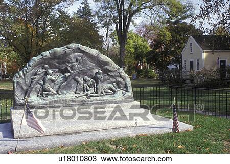 Stock Image -  Lexington, Massachusetts, A stone Memorial to the Lexington Minute Men 1775 is adorned by two U. S. Flags., . Fotosearch