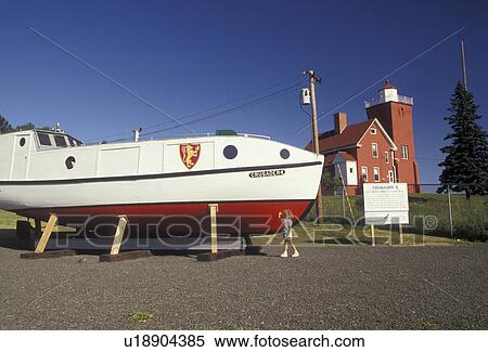 Stock Photography -  lighthouse, fishing boat, Minnesota, Lake Superior, The Cruiserder-II built in 1939 a Lake Superior commercial fishing boat at Lighthouse Point and Harbor Museum in Two Harbors in the state of Minnesota. . Fotosearch