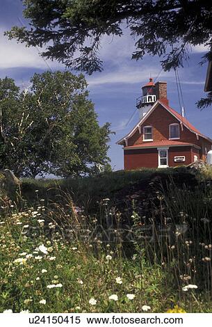 Stock Photography -  lighthouse, Upper Peninsula, U. P Michigan, Scenic view of the Lighthouse at Eagle Harbor perched up on a hill of wildflowers in the state of Michigan.. Fotosearch