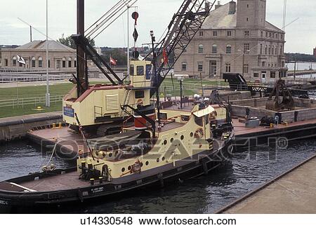 lock, Soo Locks, Upper Peninsula, Lake Superior, U. P Michigan, Sault Ste. Marie, A tugboat pushes a barge out of the lock at Soo Locks in Sault Sainte Marie in the state of Michigan. View Large Photo Image Stock Photo - lock, Soo Locks, Upper Peninsula, Lake Superior, U. P Michigan, Sault Ste. Marie, A tugboat pushes a barge out of the lock at Soo Locks in Sault Sainte Marie in the state of Michigan.. Fotosearch