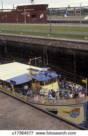 Stock Photo -  lock, Soo Locks, Upper Peninsula, Lake Superior, U. P Michigan, Sault Ste. Marie, A tourboat in Soo Locks in Sault Sainte Marie in the state of Michigan.. Fotosearch