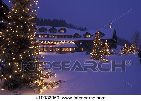 Stock Photo -  lodge, inn, resort, Trapp Family Lodge, Christmas, X-mas, Xmas, winter, Vermont, The snow covered Trapp Family Lodge is decorated with lights in the evening for the Christmas holiday season in Stowe in Lamoille County in the state of Vermont. Evergreen t. Fotosearch